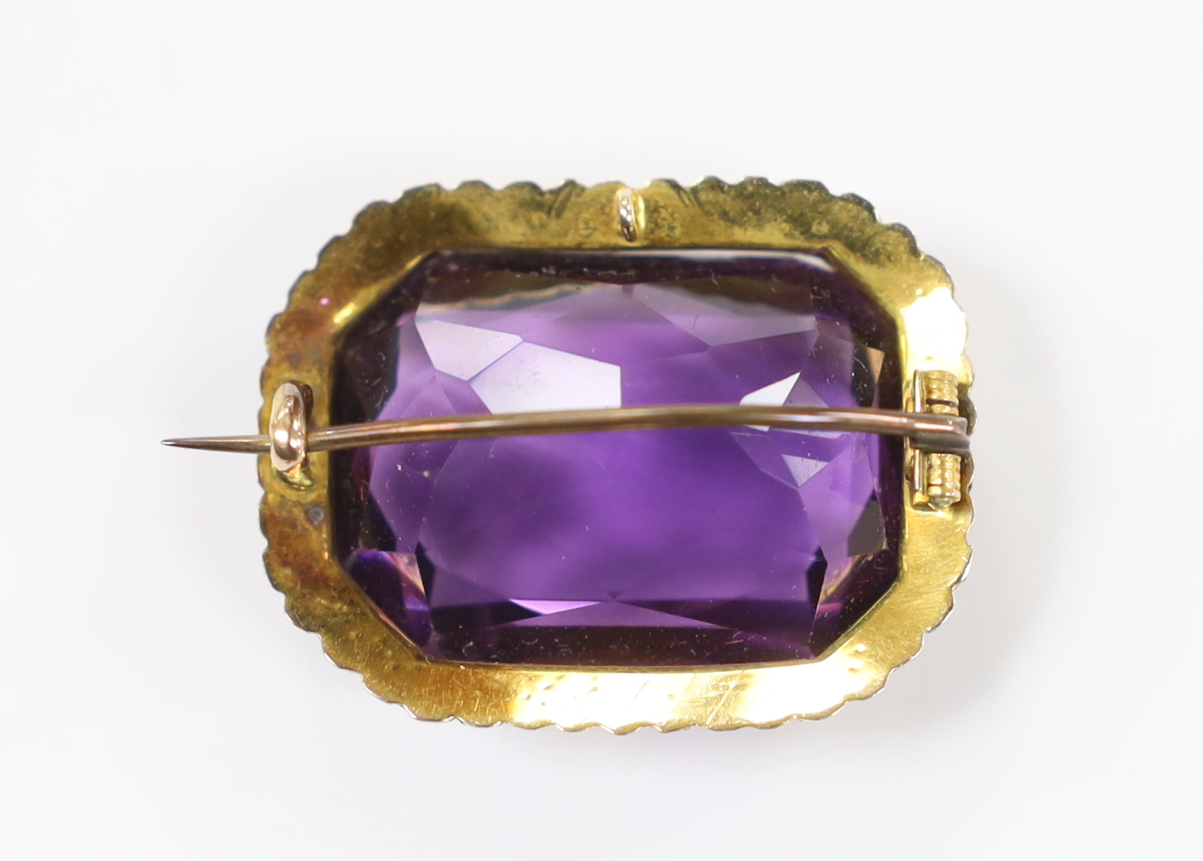 An Edwardian yellow metal mounted emerald cut amethyst and seed pearl cluster set brooch, 31mm, gross weight 11.9 grams.